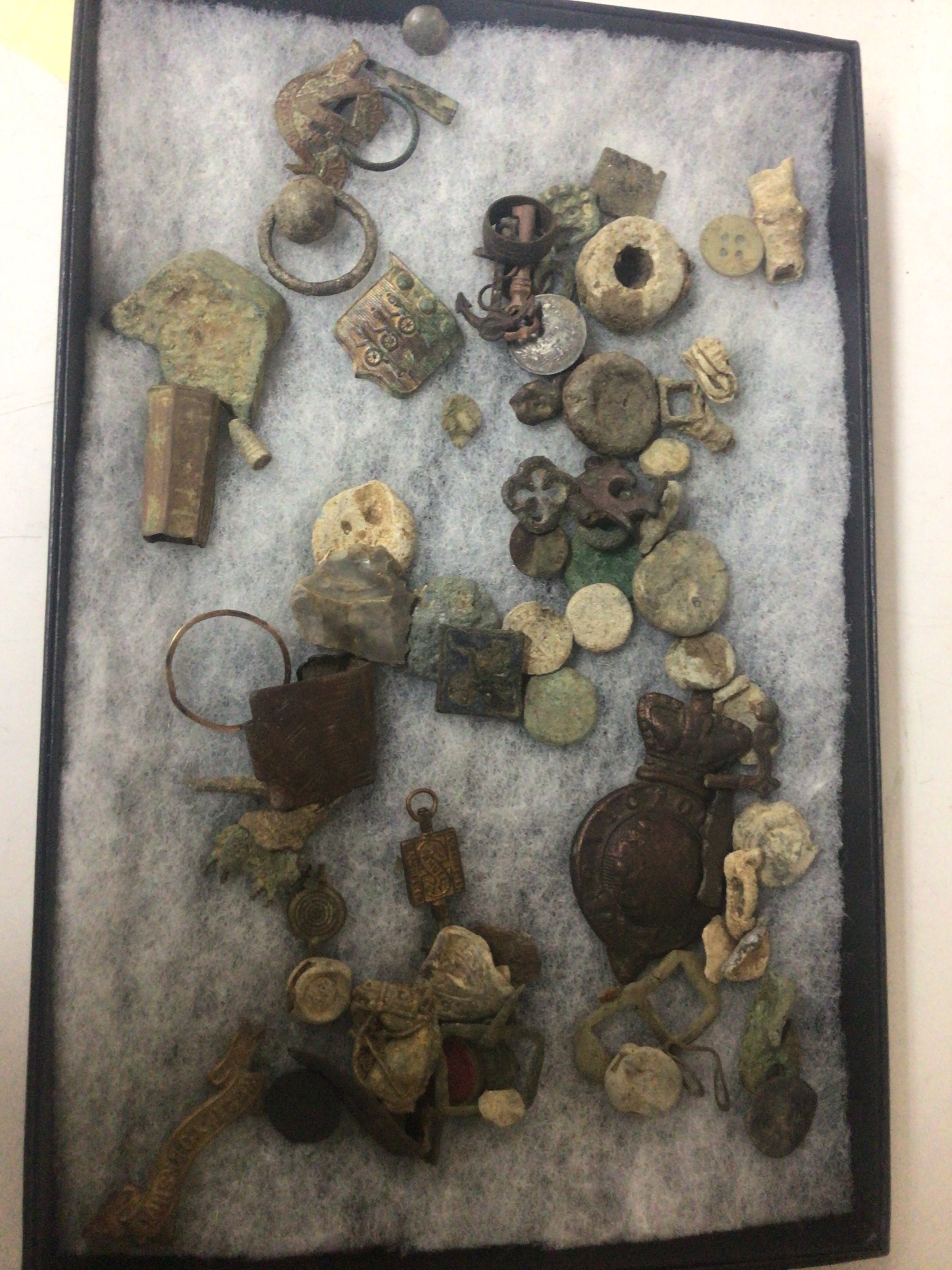 Two cases containing metal detectors finds including ancient coins and objects. 
 