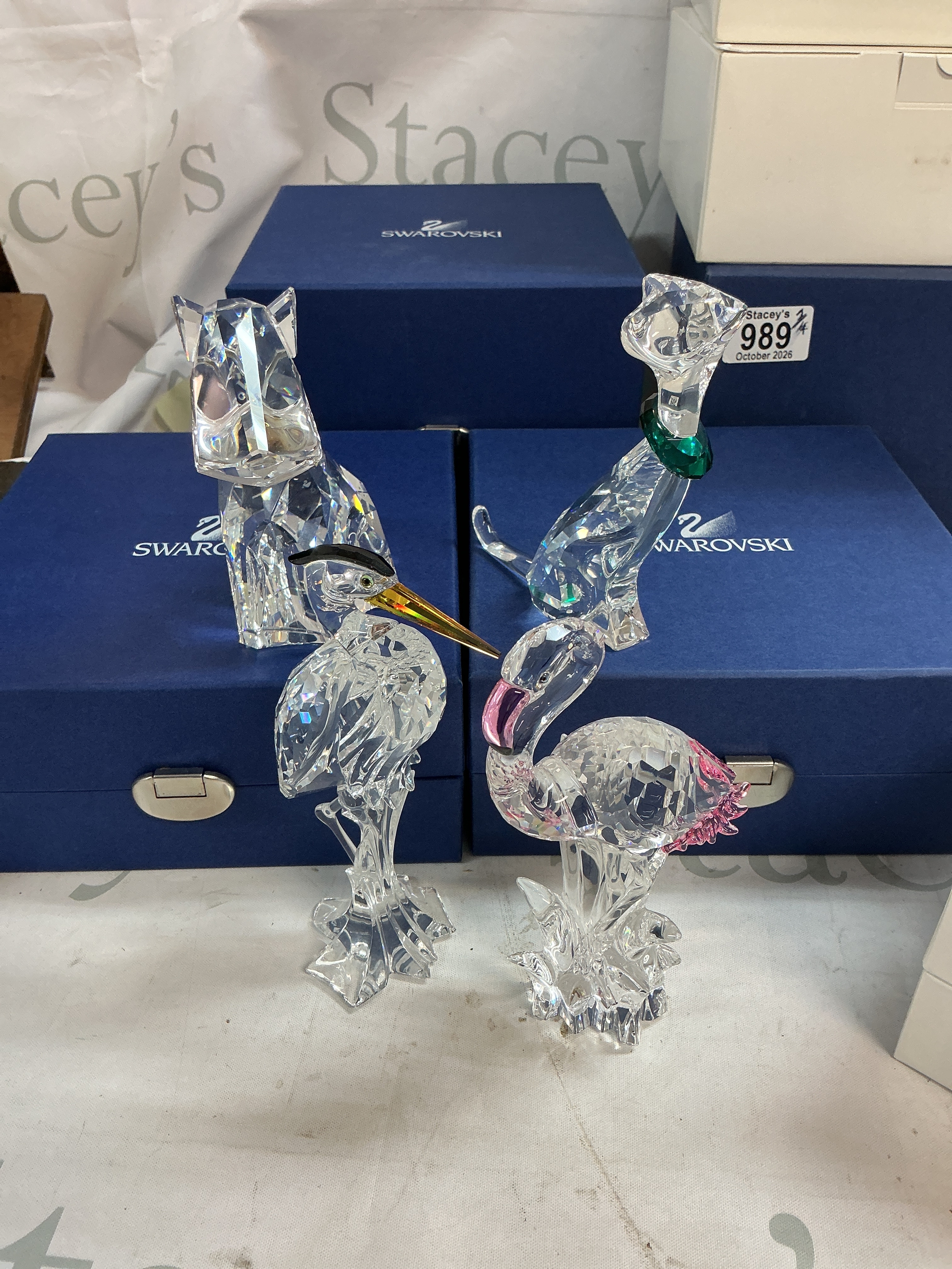 A collection of 4 Swarovski animal figures including dog, cat and birds