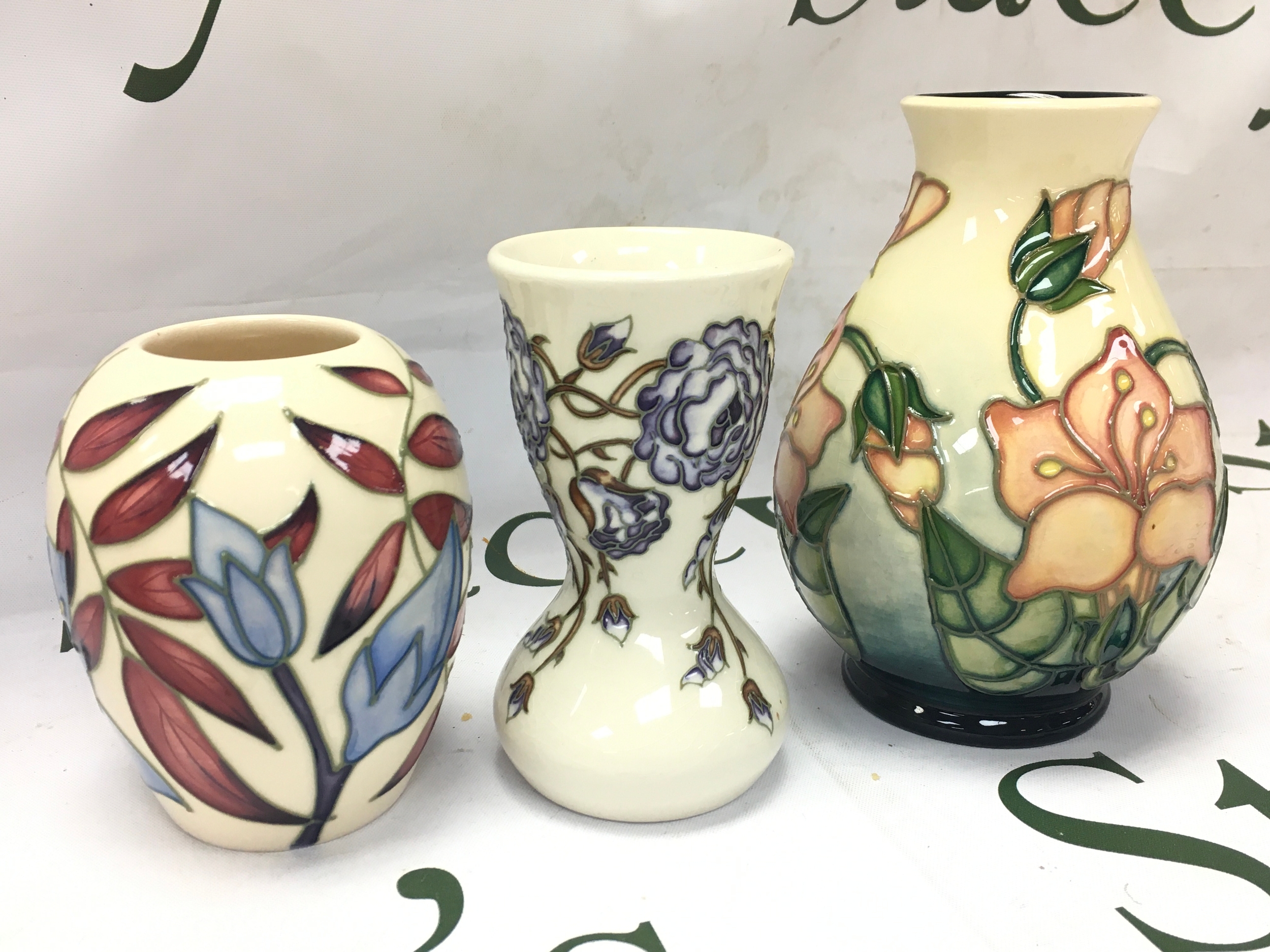 Three Moorcroft floral vases including a water cranesbill, Bluebell harmony, Jacobs ladder. 10 and 14cm tall 