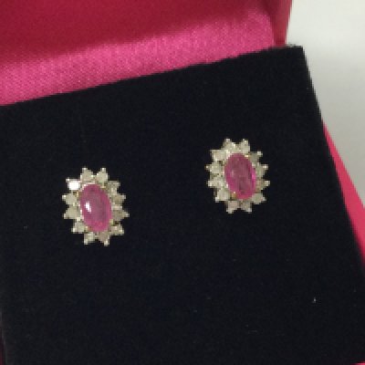 A pair of 9ct gold diamond and ruby earrings. Postage B