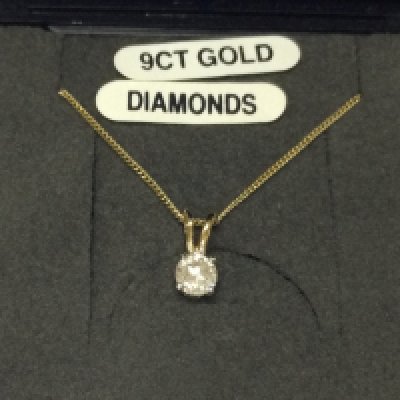 A 9ct gold chain with a diamond solitaire pendant.