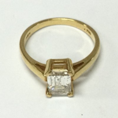 An 18ct yellow gold emerald cut diamond ring. Size N and 3.62g