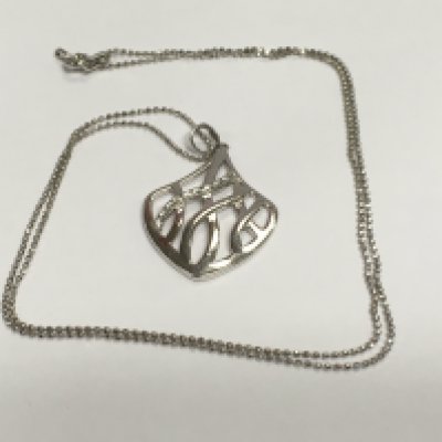 A silver openwork pendant set with cubic zirconia on a silver chain. Shipping category A.
