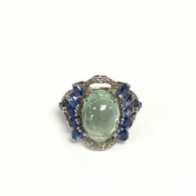 A large and unusual black rhodium coated silver dress ring set with an oval cabochon blue/green tourmaline, oval tanzanites and diamonds. Tourmaline approx 5.00ct, tanzanites approx 5.00ct, diamonds approx 0.60ct. Approx size N. Shipping category A.