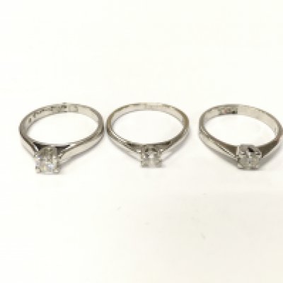 Three 18ct white gold diamond solitaire rings. Sizes L and M and approximately 8.1g total