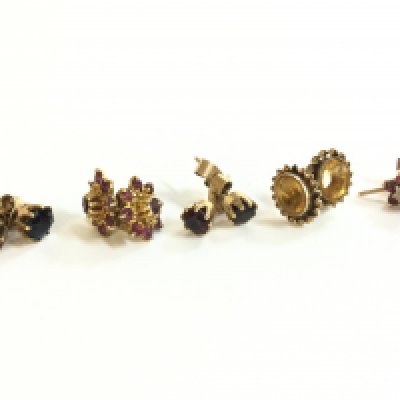 A collection of gold earrings set with various stones including black sapphires and rubies . 7.2g total weight. Postage category A