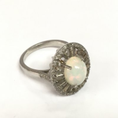 A silver ring set with an oval cabochon opal, tapered and round diamonds. Opal approx 1.85ct, diamonds approx 0.62ct. Approx size N. Shipping category A.