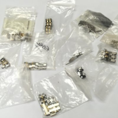 A collection of assorted bi metal watch links various makes.