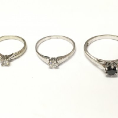 Three 18ct white gold diamond solitaire rings one with black diamond. Sizes H O T and approximately 7.3g