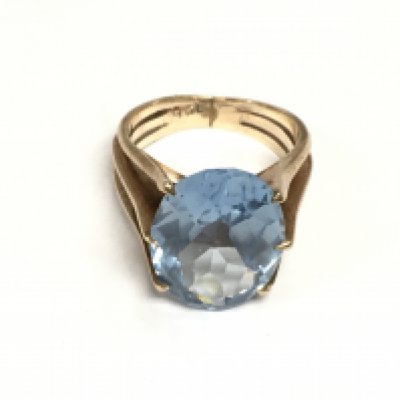 A 9ct rose gold ring set with a large blue zircon, approx 6.8g and approx size L. Shipping category A.