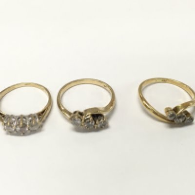 Three unmarked yellow metal three diamond rings. Sizes K and approximately 6.3g