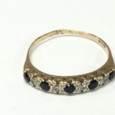 A 9ct gold diamond and sapphire set ring. V 1/2 and 2.67g