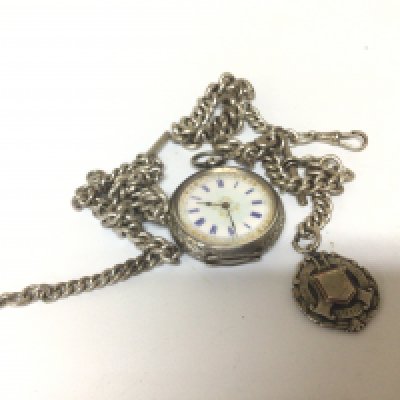 A Swiss silver Key wind pocket watch and two silver chains.