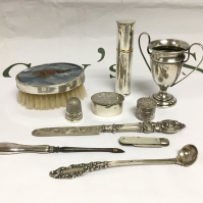 A collection of silver items comprising an atomiser, pill boxes, miniature trophy cup etc. Shipping category B.