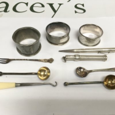 A small collection of silver items comprising propelling pencil, napkin rings, button hook etc. Shipping category B.