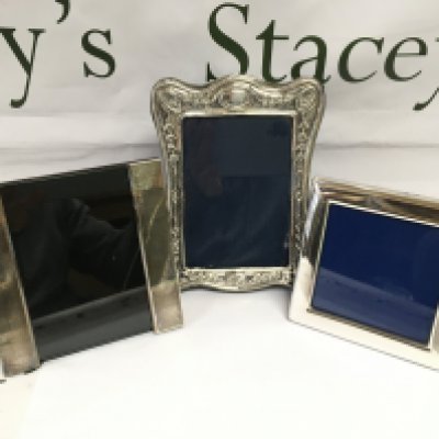 Three silver photo frames, largest approx 18cm in height. Shipping category B.