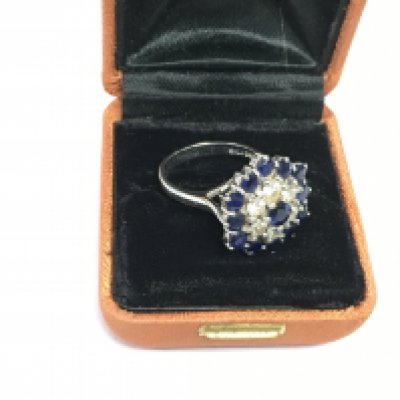 An 18ct white gold, sapphire and diamond cluster ring, approx 9.4g and approx size N-O. Shipping category A.