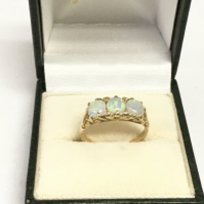 A gold and opal ring, tested at 14k, approx 3.4g and approx size M-N. Shipping category A.