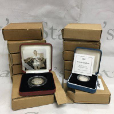 A mixed lot of 12 silver boxed proof coins.