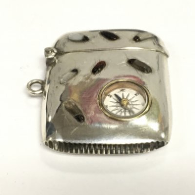 A silver shibayama Vesta case inset with a compass. Shipping category A.