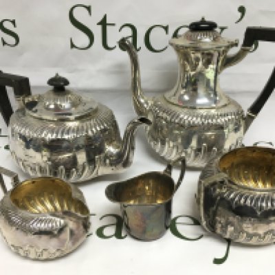 Five silver tea service items comprising four matching but having different hallmarks. Shipping category B.