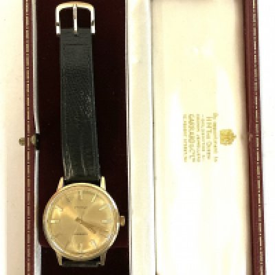 A vintage Garrard Eterna gents gold cased wrist watch.presented by Ford.