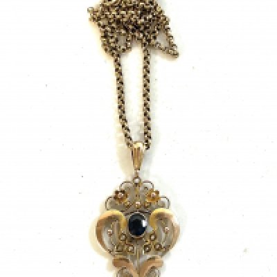 A good art nouveau 9ct gold pendant and chains together inset with sapphire and seed pearls.