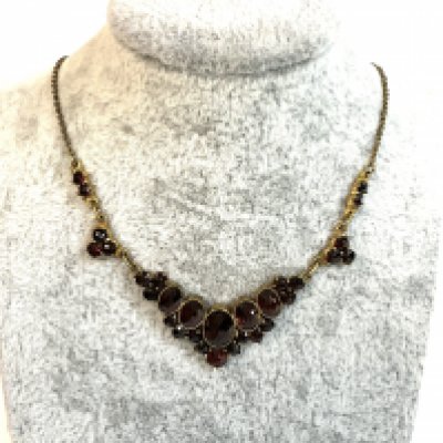 A vintage yellow metal and garnet necklace.