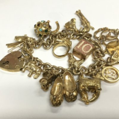 A 9ct gold charm bracelet, approx 58.4g. Shipping category A.