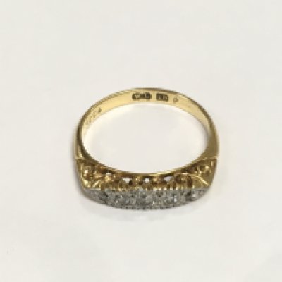 An 18ct gold ring set with five small diamonds, approx 3g and approx size L-M. Shipping category A.