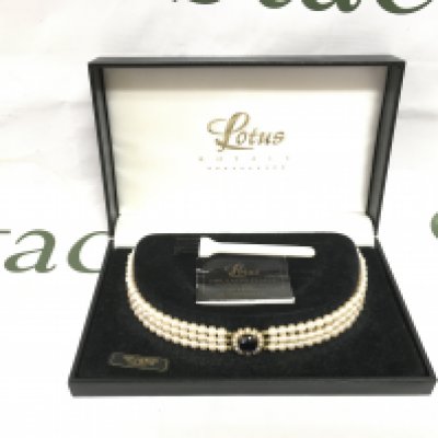 A boxed Lotus simulated pearl necklace, Shipping category B.
