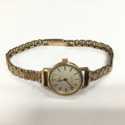 A 9ct gold ladies Garrard watch with personal inscriptions. Shipping category A.