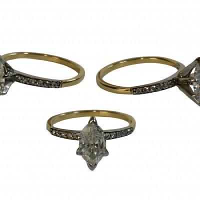 An 18ct yellow gold ring set with a marquise cut diamond solitaire, approximately 1.2ct, with diamonds inset into set shoulders. Size R.