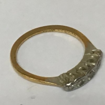 An 18carat gold ring set with five small diamonds. Weight 2g.