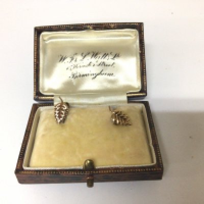 A pair of 9carat gold earrings in the form of leaves. In a vintage box 0.8g