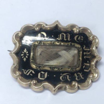 An unmarked gold mourning brooch.