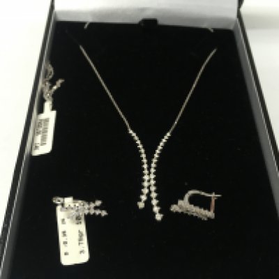 A 14ct white gold two row diamond necklace with matching earring. Postage B