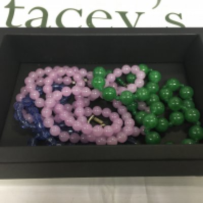 A box containing polished stone necklaces.