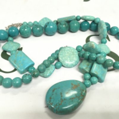 A box of polished stone necklaces.