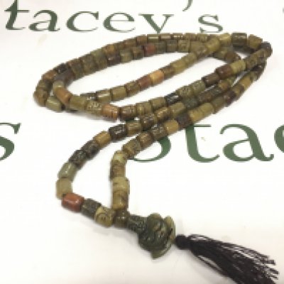 A 29&#2013266057۝ polished bead necklace with detailed beads and a Buddha style pendant.