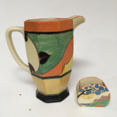 A Clarice Cliff ceramic jug (cracked) and a sugar bowl no damage (2)