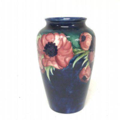 A Moorcroft vase with floral Anemone pattern on a deep blue ground signed base by Walter Moorcroft circa 1949 no obvious damage. Height 22cm.