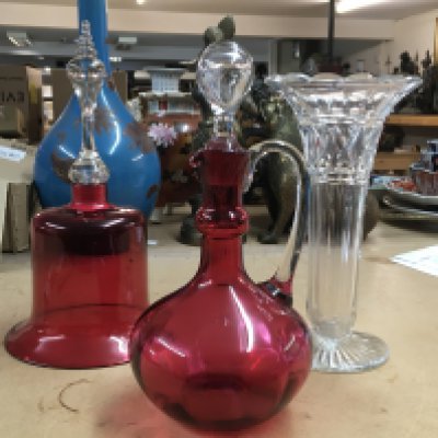 A cranberry Glass bell, cranberry glass jug and trumpet glass vase