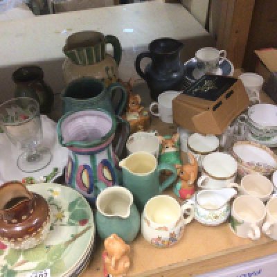 A collection of ceramics jugs cups and saucers Pendelfin figures a Doulton jug a Wedgwood Susie Cooper glen mist pattern coffee set and other ceramics