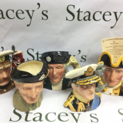 Nine Royal Doulton character jugs including Lord Kitchener, Henry V, Captain Cook and others. Includes eight boxes. Shipping category D.