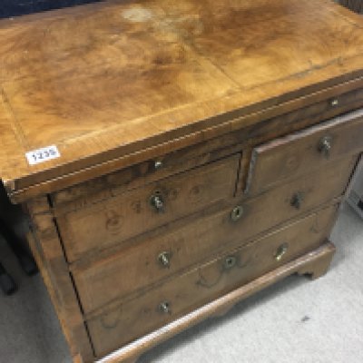 A Georgian walnut bachelors chest with brushing slide fitted with two short and two long drawers. On bracket feet