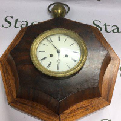 An octagonal shaped eight day wall clock, approx height 50cm. Shipping category D.