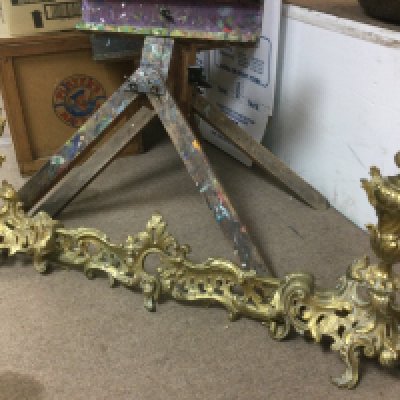 An ornate brass extending fender. Shipping category D.