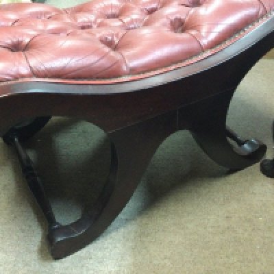 Two X framed stools with button seats .