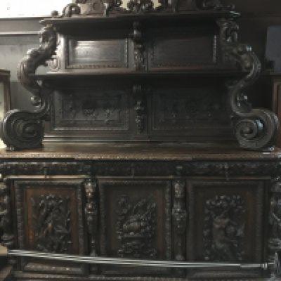 A large oak Sideboard profusely carved With figures, animals,fruit and foliage the raised back with two selfs above three drawers And three cupboards on a plinth base . 198 cm x 240 cm